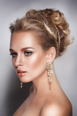 blond beauty woman portrait with golden hair jewelry and ear-rings