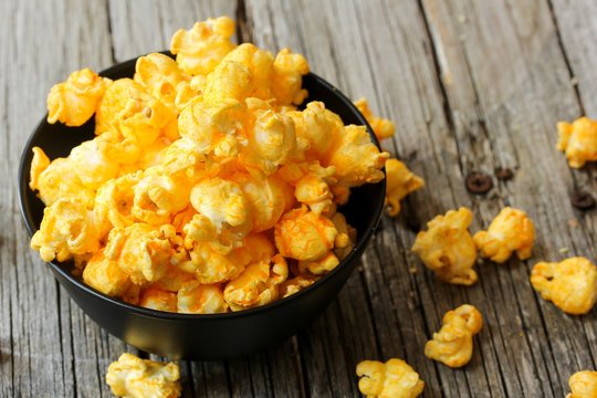 Cheese Popcorn In A Black Bowl, Selective Focus