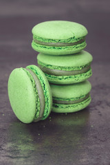 Green macaron. A stack of green tea  macaron on rustic background  