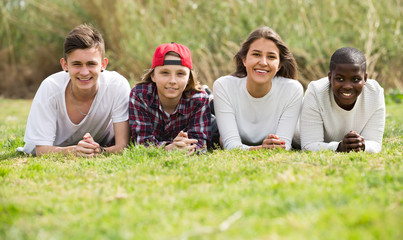 Happy teenage friends in park.