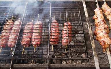 Grilled meat over the coals on a barbecue, kebab. Street food