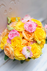 Beauty of yellow flowers. Bridal accessories. Close-up bunch of florets. Details for marriage and for married couple. Wedding bouquet with yellow roses and ribbons