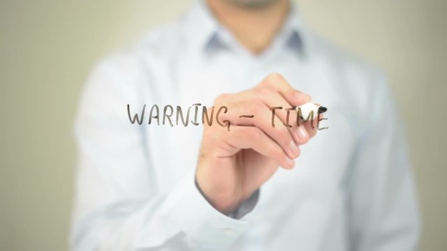 Warning - Time waster Ahead, man writing on transparent screen