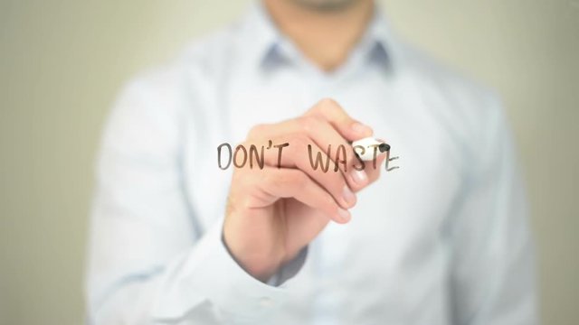 Don't Waste Your Time, man writing on transparent screen