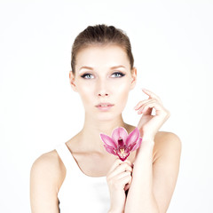 Portrait of woman with permanent make up holding pink flower. Beauty concept. Elegant and beautiful woman.