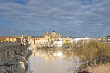 Fototapeta premium Panoramic view of the historic center of Cordoba. The Roman Bridge across the Guadalquivir river and the Cathedral-Mosque of Cordoba. Andalusia. Spain.