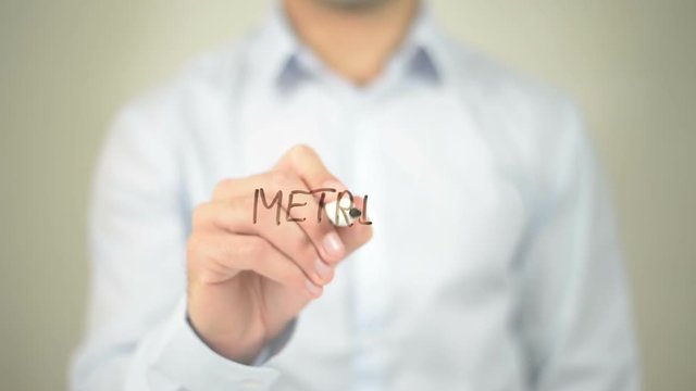 Metrics , man writing on transparent screen