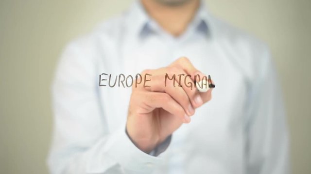 Europe Migrant Crisis  , man writing on transparent screen