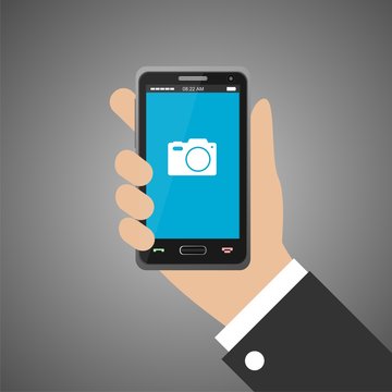 Hand holding smartphone with camera icon