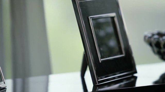 Picture frames on side table tracking shot