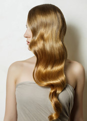 Fototapeta premium a large portrait of a girl with beautiful hair on a white backgr