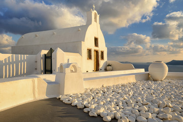 White church during sunset in Santorini, Greece