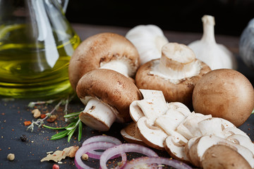 Button mushroom with rosemary, onion and peppercorns. Still life