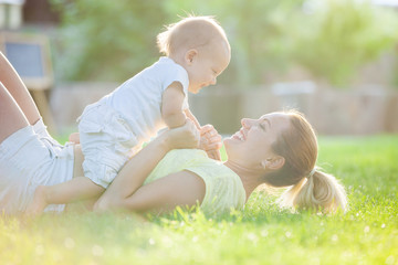 Young woman and her son having fun outdoors 