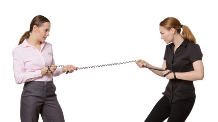 two woman pulling on a telephone wire