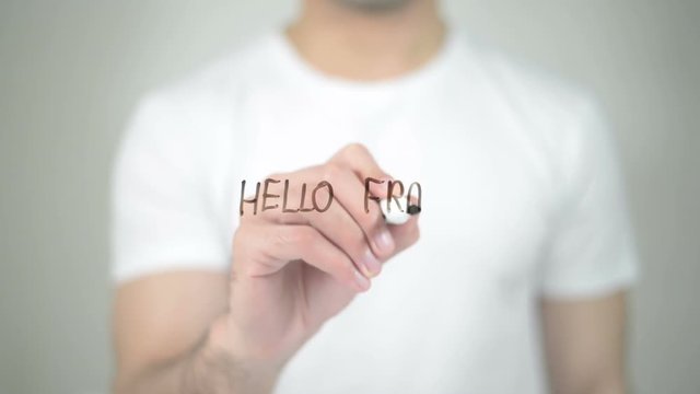 Hello France, man writing on transparent screen