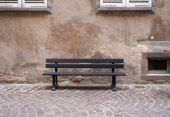 Dark Brown color outdoor bench with rustic wall