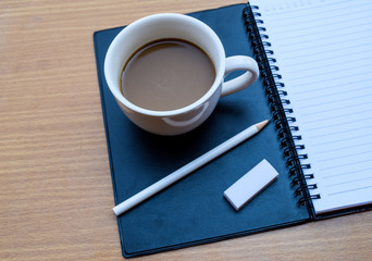 Obraz na płótnie Canvas office tatle with cup of coffee
