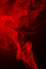 Abstract red smoke from aromatic sticks.