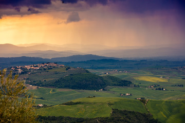 Fototapeta premium Tuscany valley in stormy weather at sunset, Italy