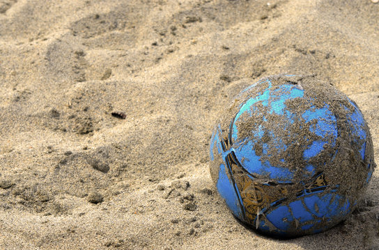 Balon de F&uacute;tbol desgastado en la playa