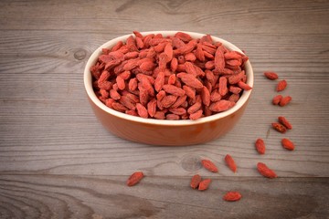 Goji. Goji berries arranged on wood. Goji berries.