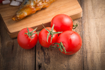ripe small tomatoes on wood background

