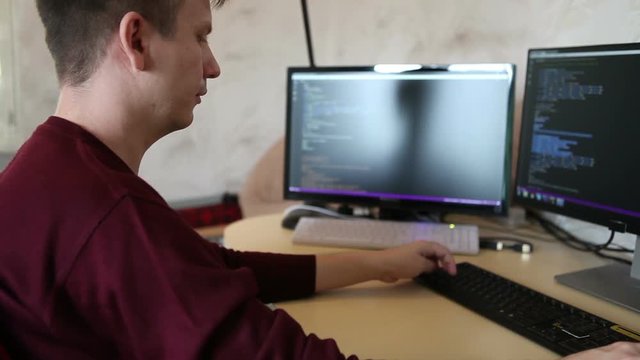 A man working at a computer programmer. Testing the program code