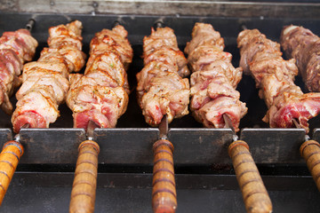 Grilled meat over the coals on a barbecue, kebab. Street food