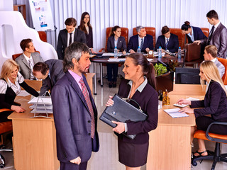 Fototapeta na wymiar Happy business people in office. Man handshake woman.