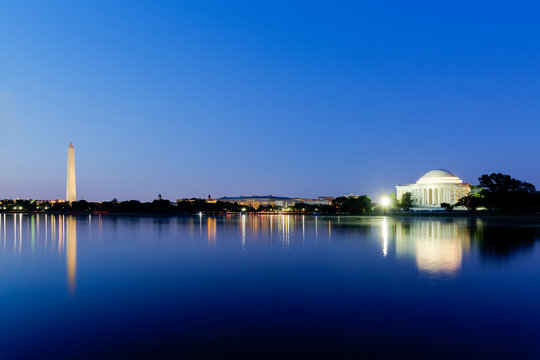 Jefferson Memorial and Washington Monument across the tidal basin at dusk during the blue hour