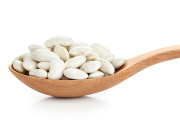 Wooden spoon with beans isolated on white background.