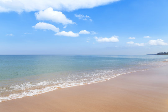 Empty tropical beach and sea with white cloud and blue sky in Thailand