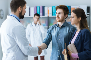 Patient and doctor shaking hands