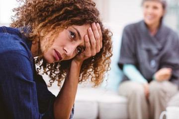 Upset woman with head in hand 