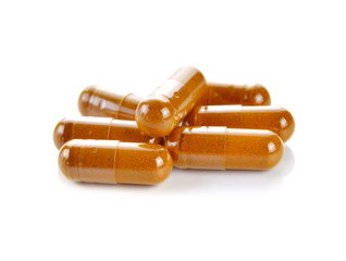 herb turmeric capsules on white background