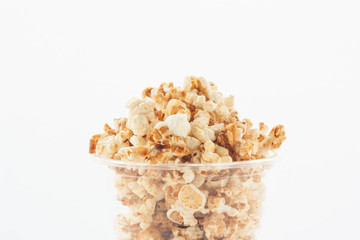 Popcorn in plastic cup on white background.