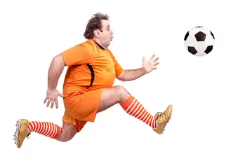 Fotobehang recreational fat football player kicking the ball isolated on a white background © milkovasa
