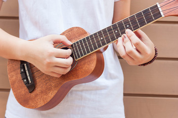 Fototapeta premium Teen asian women with ukulele in her free time.