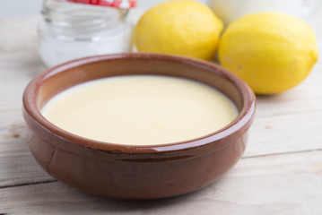 Traditional creme brulee on ceramic dish on wooden table