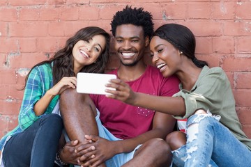 Friends taking selfie on a mobile phone