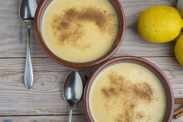 Traditional creme brulee on ceramic dish on wooden table