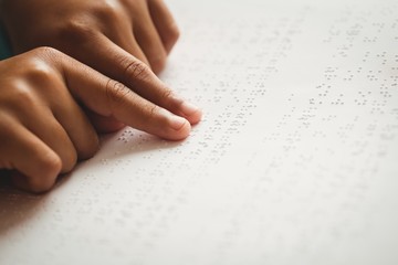 Child using braille to read - obrazy, fototapety, plakaty