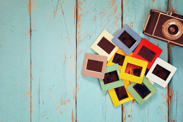 top view of old slides frames over wooden background