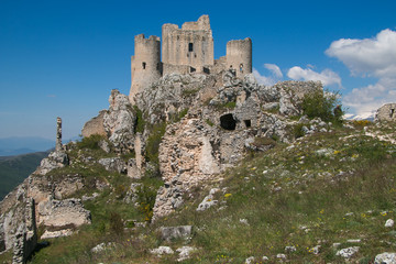 Fototapeta na wymiar Old castle in the sky. Panoramic view of Rocca Calascio with wild flowers in Abruzzo.