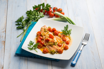 salmon trout fillet with leek and fresh tomatoes