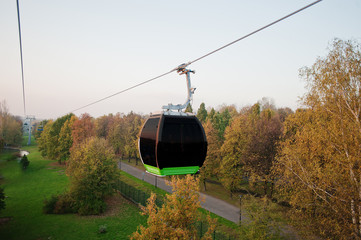 Cable car at autumn park in evening sunset
