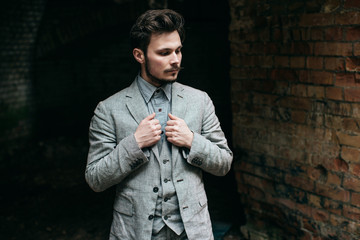 Portrait Elegant bearded vintage retro young handsome Businessman man hipster with mustache, Outdoor, jacket, ruins