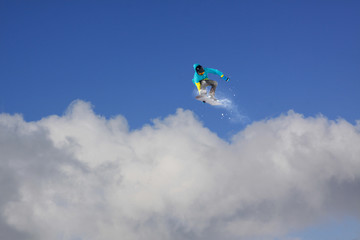 Obraz na płótnie Canvas Snowboard rider jumping on mountains. Extreme snowboard freeride sport.
