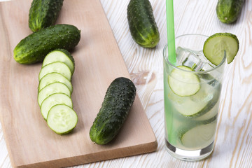 Summer cucumber cocktail and sliced cucumbers.